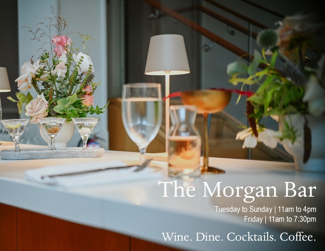 Tabletop with flower arrangements and glasses.